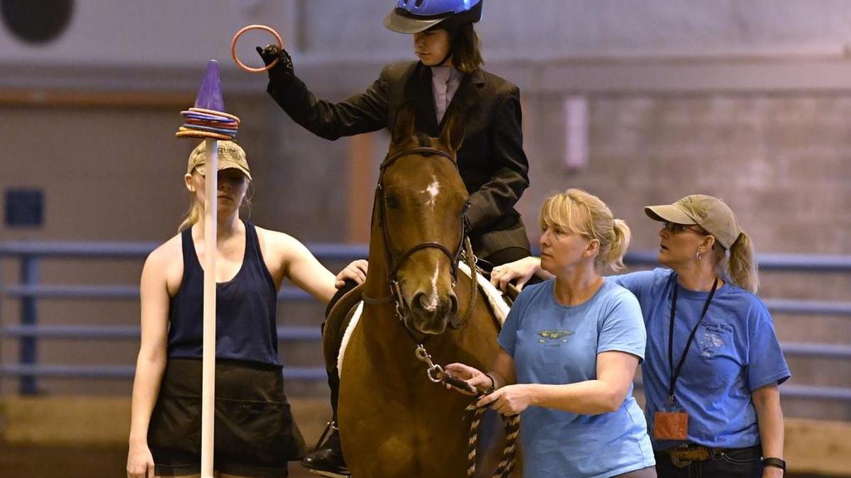 Abby Stroop, of Montoursville, competes in the trail obstacle event. The 2016 Special Olympics Pennsylvania Summer Games equestrian events were held Thursday at the Snider Ag Area at the Penn State.