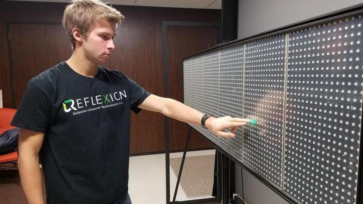 Reflexion Interactive Technologies co-founder Matt Roda tests the Edge, a concussion monitoring device developed by the company, in the Center for Sports Concussion Research at Penn State University’s Rec Hall.