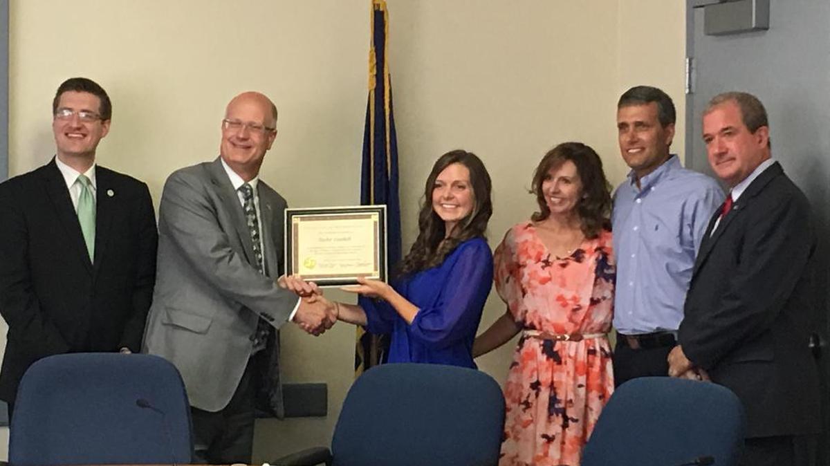 Taylor Guelich, center, was recognized by the Centre County Board of Commissioners Tuesday for her academic excellence. Taylor, 17, is a junior at Penn State and is expected to earn her master’s degree by age 20. From left, Chairman Michael Pipe; Vice Chairman Mark Higgins; Taylor, her parents, Kirsten and Dan; and Commisioner Steve Dershem.