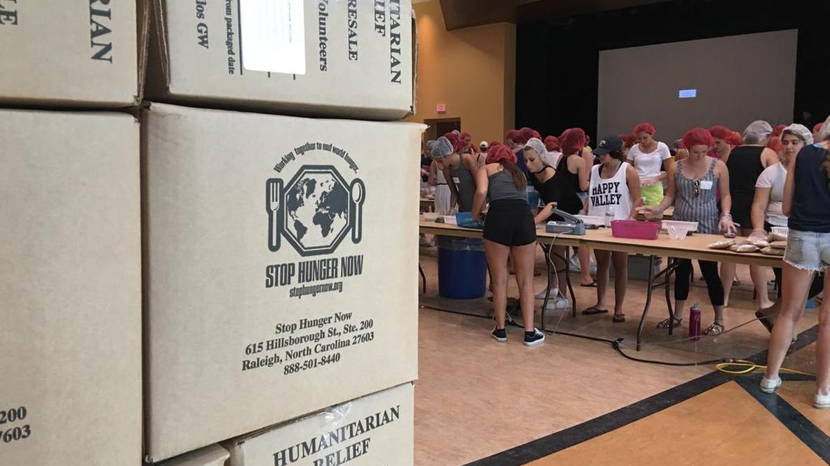 Penn State female students, mostly freshmen, fill packages for the Stop Hunger Now meal packing program as part of the Panhellenic Council’s potential new members’ day of service. The event was geared toward students who are seeking to join the university’s sororities this fall.