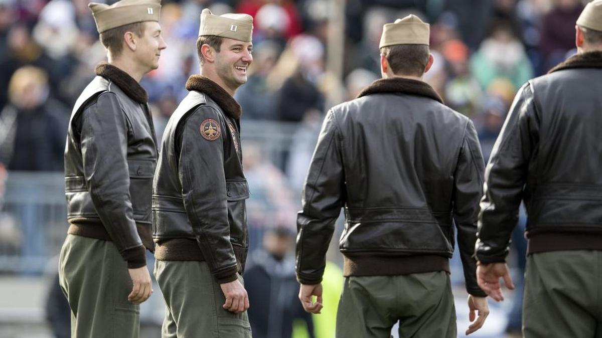 State College grad Lt. Alex Fletcher laughs as he and fellow U.S. Navy F/A-18 Super Hornets pilots are recognized for their flyover ahead of the Penn State football game against Rutgers on Veterans Day.
