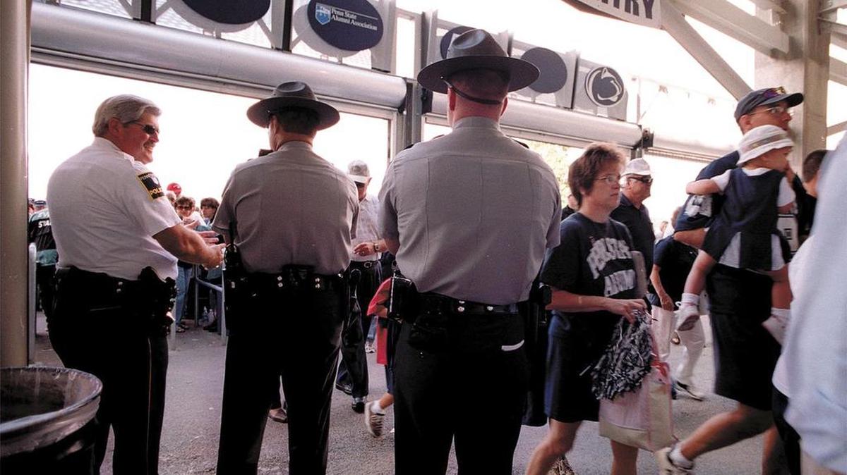 Pennsylvania State Troopers join Penn State police at the entry gates at Beaver Stadium.