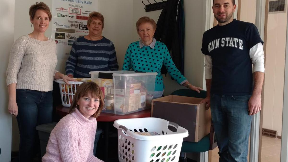 Matt Barone, far right, of Penn State Students Engaging Students, delivers 15 baskets full of food to Interfaith Human Services as part of the student organization’s annual Thanksgiving basket drive. The student organization delivered more than 350 baskets this year to Centre County nonprofits for the low-income families they support.