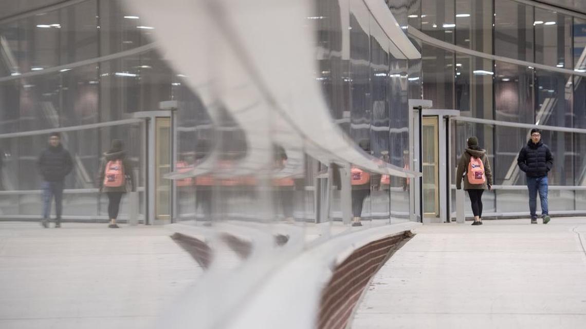 People cross the Penn State IST Bridge on Friday. A team of Penn State students are working on a program that will translate World Campus assignments for students and teachers.