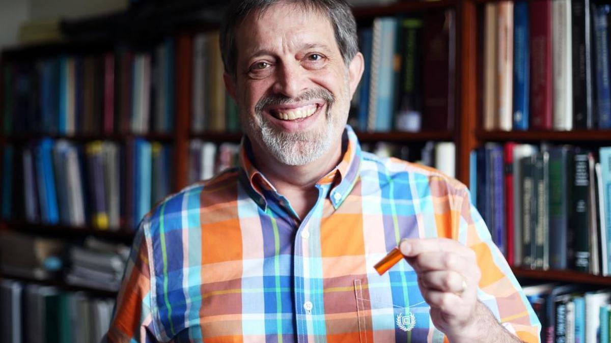 Penn State professor Greg Ziegler holds up a colorant sample Monday in his office at The Rodney A. Erickson Food Science Building.