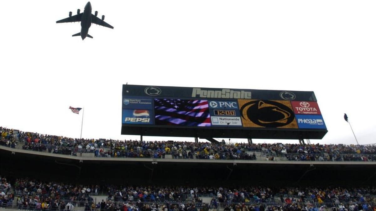 A jet flies over Beaver Stadium as the National Anthem is played before the Penn State vs. Northwestern football game.