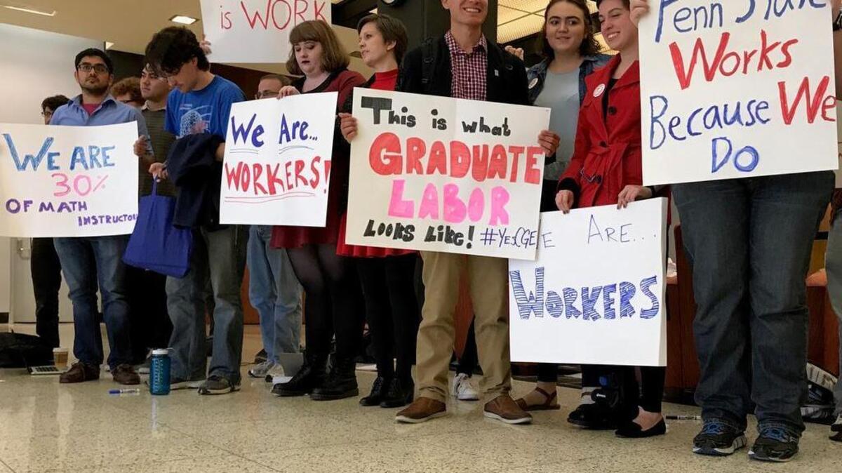 About 25 graduate students held a demonstration in Penn State’s Kern Building on Thursday in support of unionization, which the university opposes.
