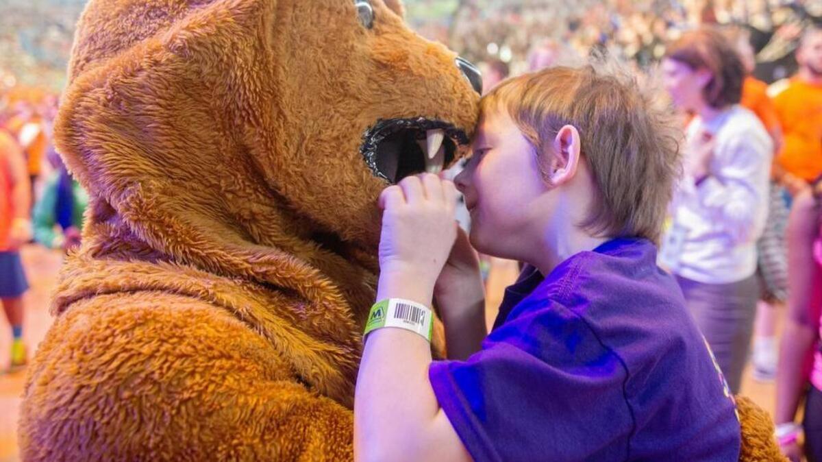 Four Diamonds child Corban Potter, 6, takes a look at the Nittany Lion’s teeth during the Penn State IFC/Panhellenic Dance Marathon on Sunday, February 21, 2016, in the Bryce Jordan Center.
