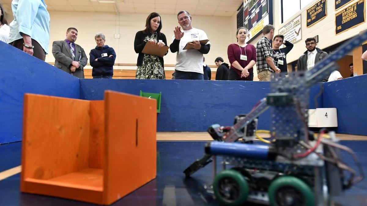 Judges Lynsey Reese and Jeff Shockey watch a State College Area High School team robot at the annual Sea, Air and Land Challenge held Friday at Bald Eagle Area High School.