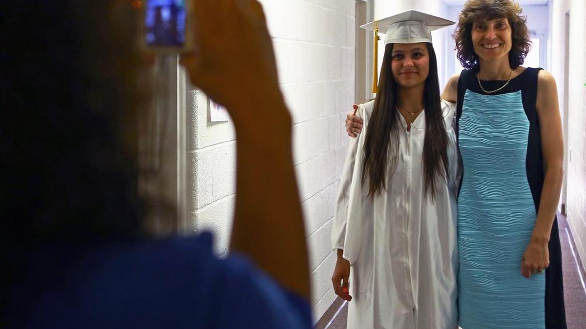 Centre County Christian Academy graduating senior Alexis Rossman poses with her aunt, Paula Brake from St. Louis, as mother Cathy Rossman takes a photo in the basement of the Calvary Bible Church in Centre Hall prior to the commencement ceremony on Friday, June 10, 2016.