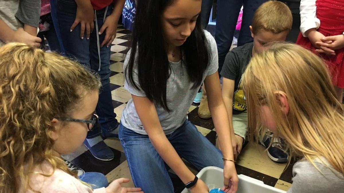 From left, Autumn McCloskey, Evelyn St. Amant and Madison Bohn work on apple boat projects at St. John Catholic School.