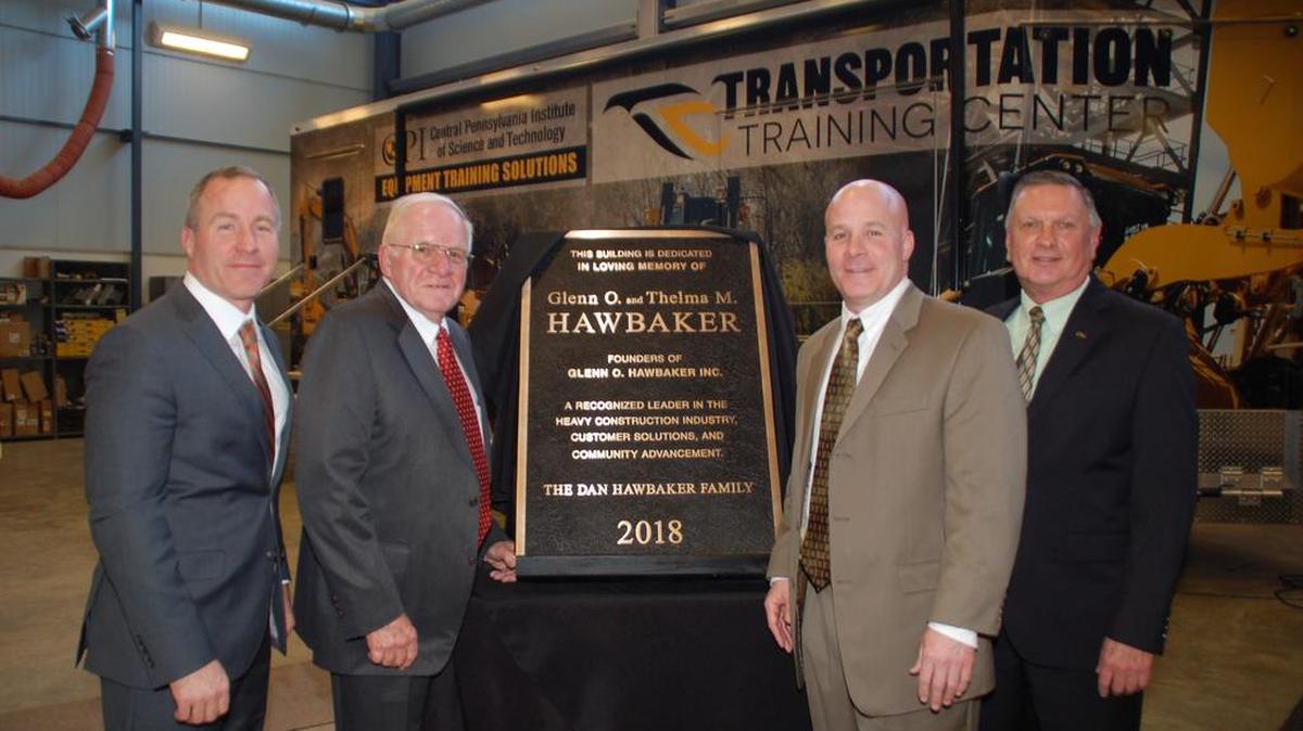 From left, Mike Hawbaker, Dan Hawbaker, Patrick Hawbaker, Richard Makin, CPI president, pose for a photo with a commemorative plaque.