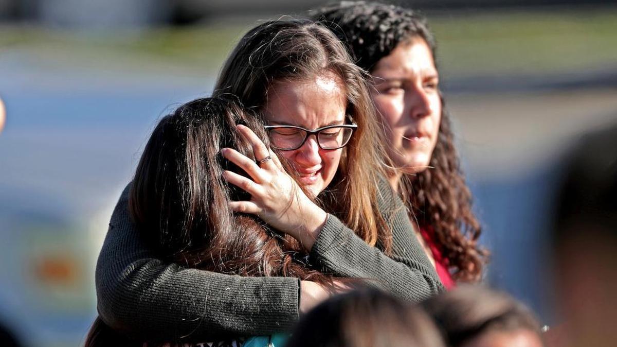 Students released from a lockdown embrace following following a shooting at Marjory Stoneman Douglas High School in Florida on Wednesday.