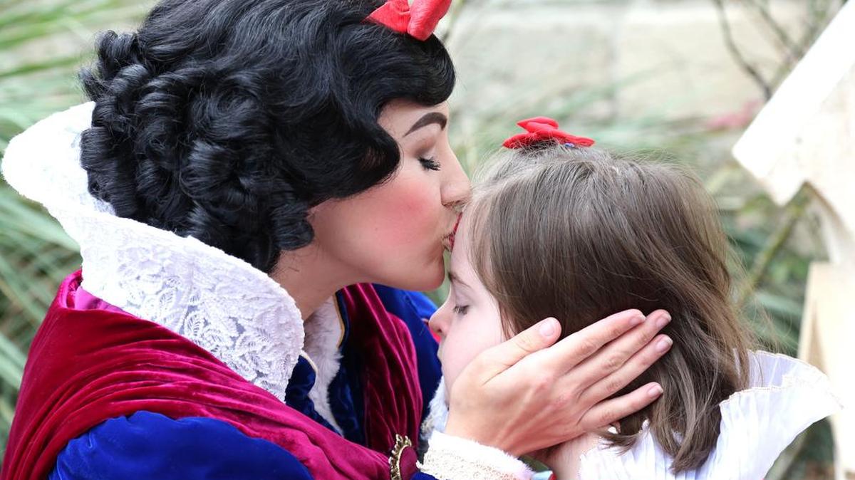 Snow White gives a kiss to Emma Miller, 10, on a trip to Walt Disney World. Emma’s family started the nonprofit, Pixie Dust Wishes to help other families with special needs children get the opportunity to visit Disney.