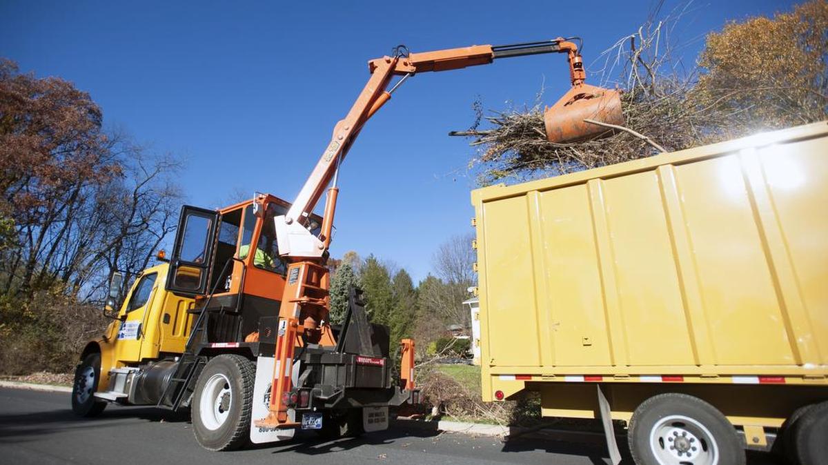 Ferguson Township Public Works crew member Aaron Zellers picks up leaves and brush using the new equipment Monday in State College.