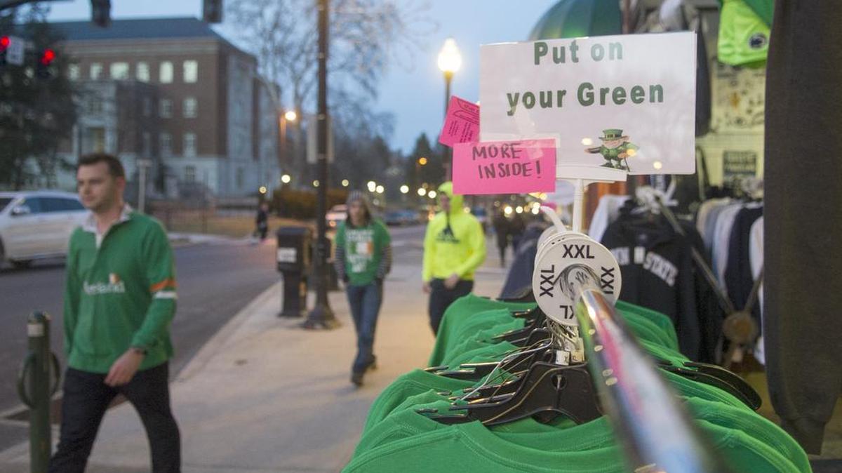 Green shirts are on sale outside The Family Clothesline on East College Avenue as pedestrians walk by in State Patty’s Day gear on Saturday, Feb. 27, 2016. This is the 10th year of State Patty’s Day, which was created when St. Patrick’s Day fell on Penn State’s spring break in 2007.