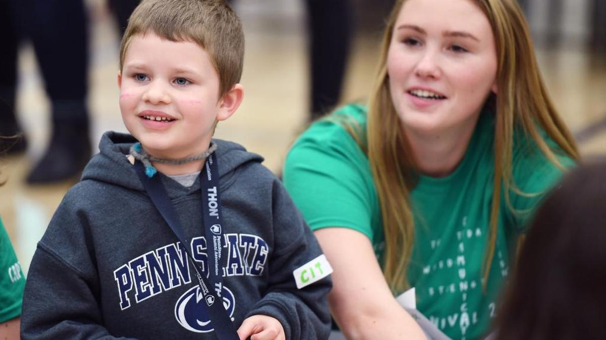 Declan Homan smiles during a game of Duck, Duck, Goose on Sunday at the Penn State Thon’s Family Carnival.