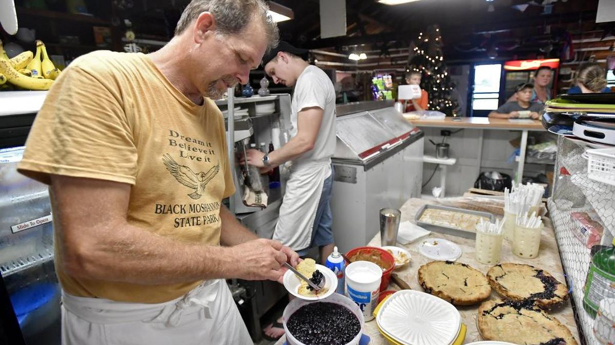 Dallas Stucke makes a blueberry shortcake sundae during the Blueberry Ice Cream Social on Saturday at Black Moshannon State Park.