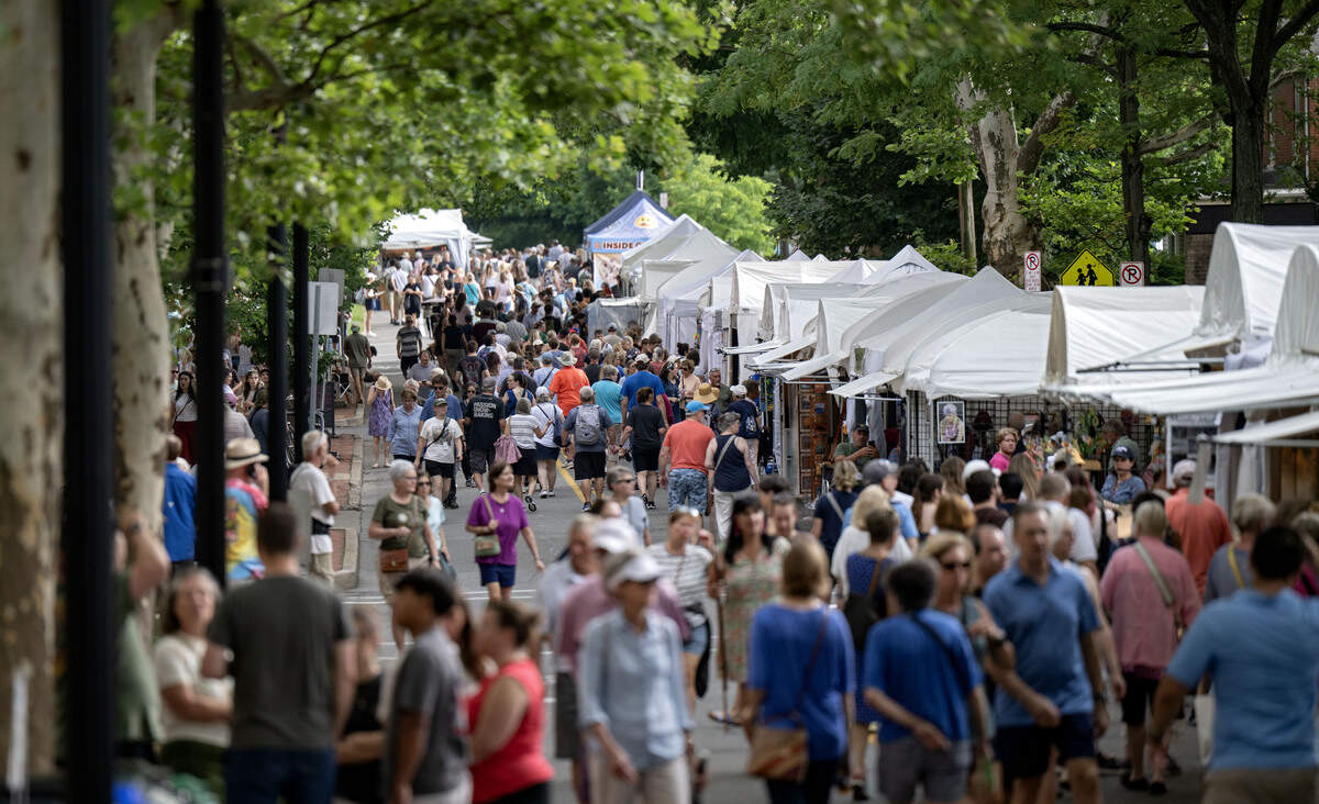 Visitors browse the booths along Allen Street during the Central Pennsylvania Festival of the Arts on Friday, July 10, 2026.
