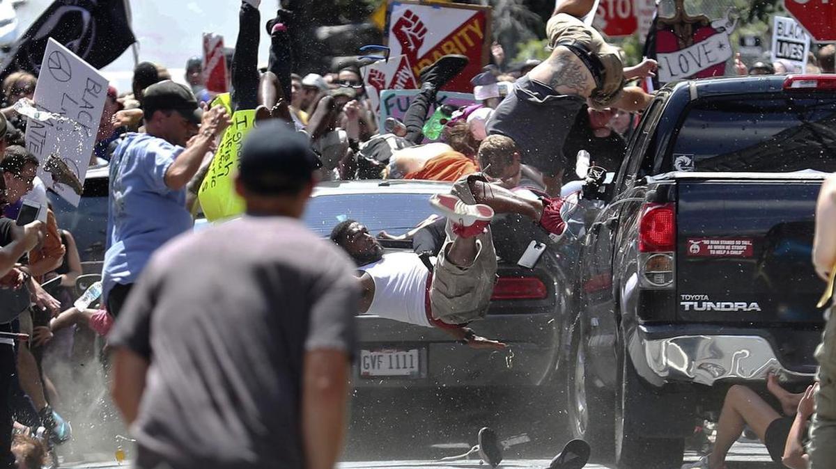 People fly into the air as a vehicle drives into a group of protesters demonstrating against a white nationalist rally in Charlottesville, Va., Saturday. The nationalists were holding the rally to protest plans by the city of Charlottesville to remove a statue of Confederate Gen. Robert E. Lee.