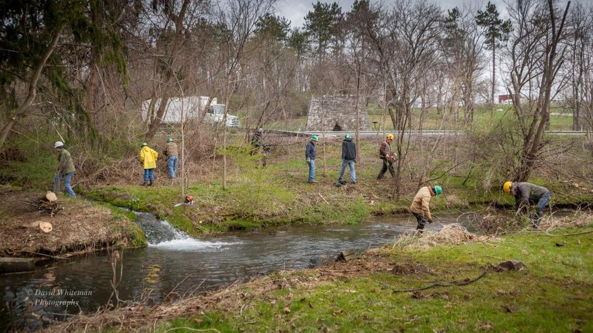 Members of the Spring Creek Chapter of Trout Unlimited and a four-man Penn State work crew helped fly fishing legend Joe Humphreys on Friday clean up Thompson Run in College Township.
