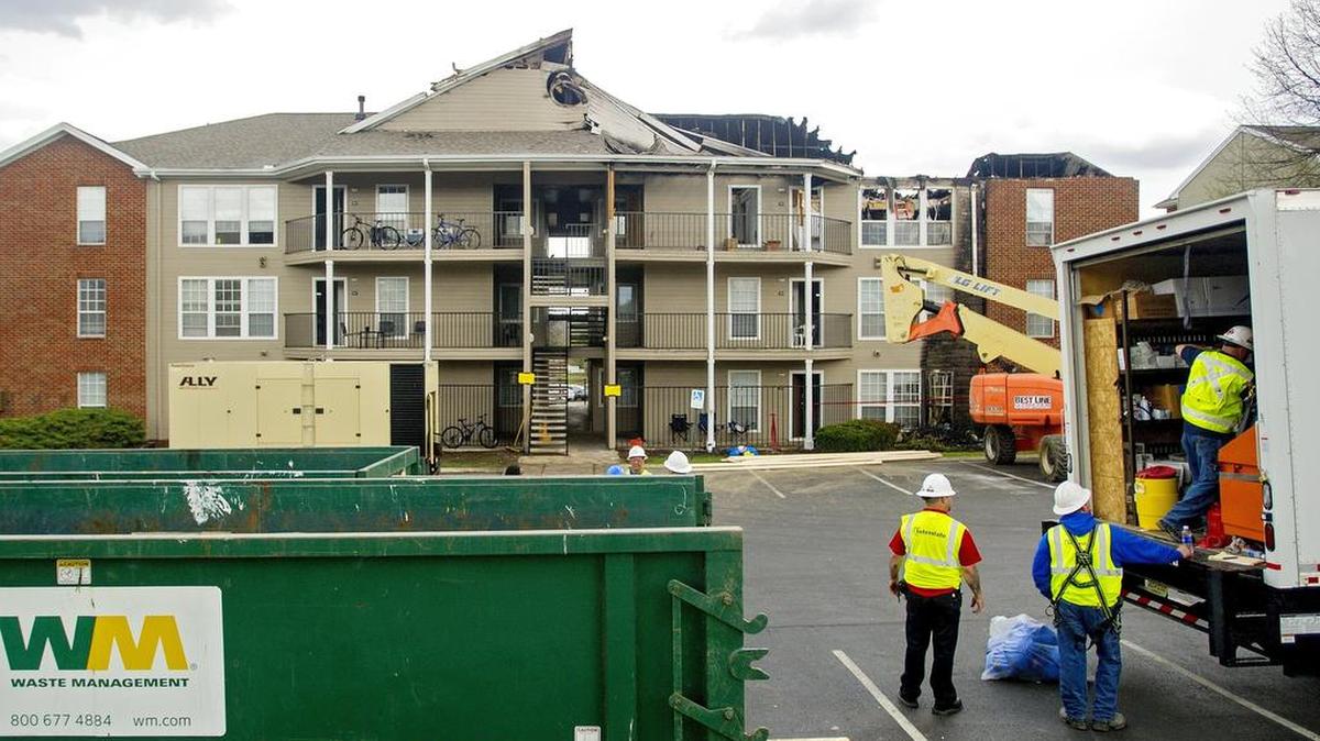 Crews work to clean up the scene from the fire at Building 13 of The Park at State College on Friday. Wednesday night’s fire caused the attic on one side of the building to collapse and displaced 48 students.