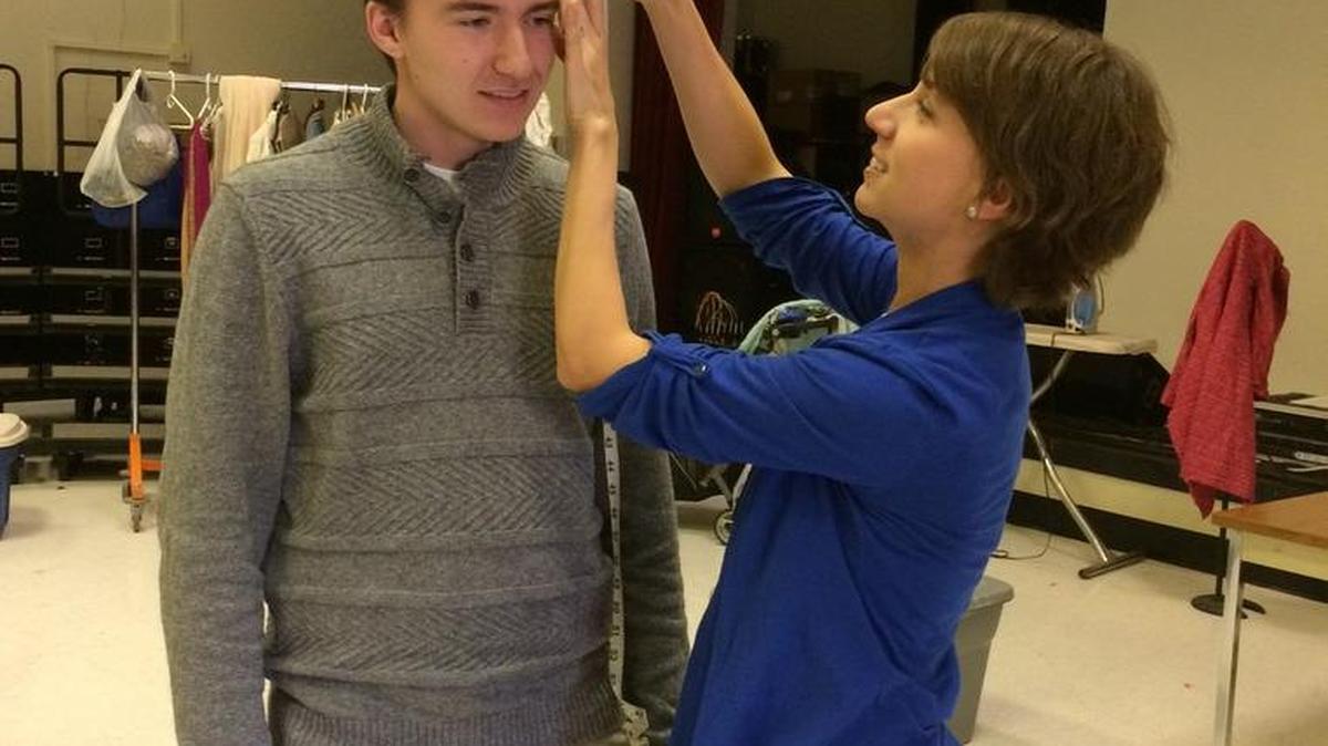 Local costumer Julie Snyder measures State High Thespian member Justin Shondeck for a costume for a production of “Peter and the Starcatcher.”