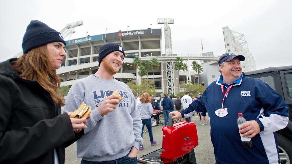 Penn State fans and Centre county residents Christina and Nathan Ulmer enjoy some bratwursts before the TaxSlayer Bowl against Georgia on Jan. 2 at EverBank Field in Jacksonville, Fla.