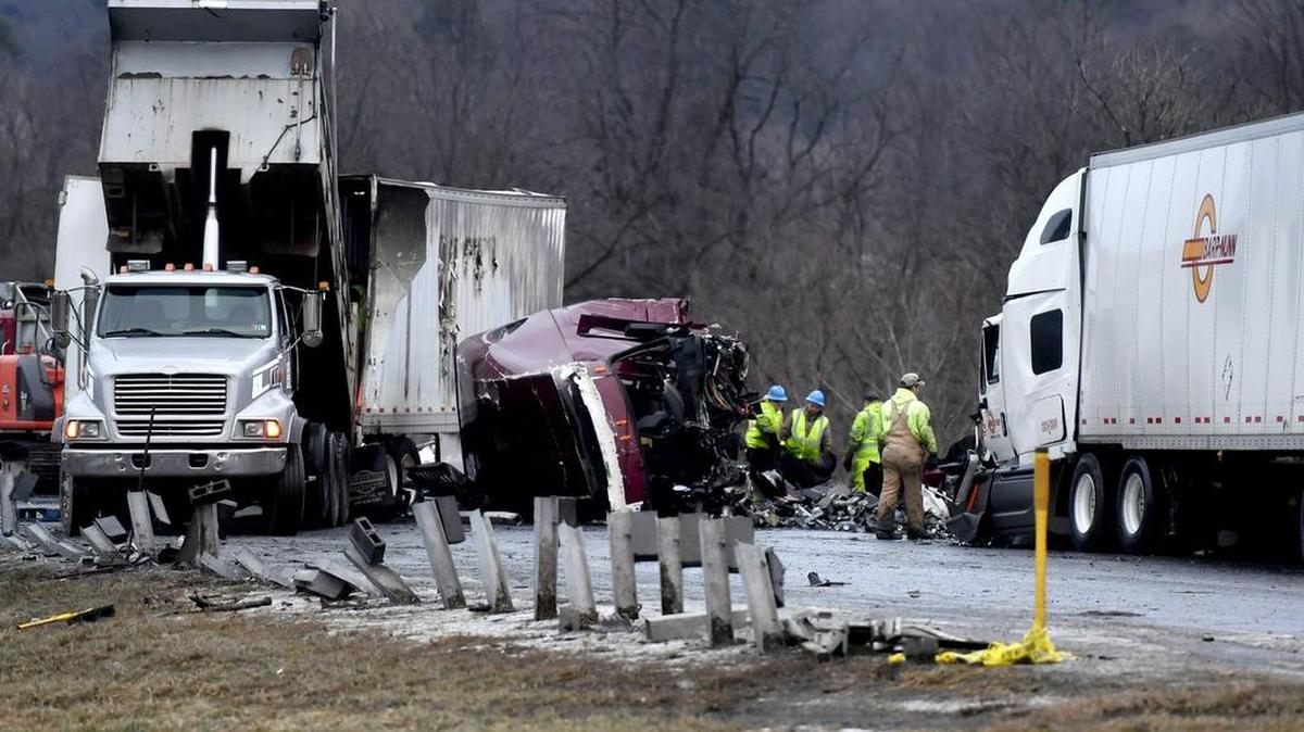 Workers clean up a multivehicle crash on I -80 eastbound between Bellefonte and Lamar on Jan. 11. The accident happened about 12:30 a.m. and had two fatalities.