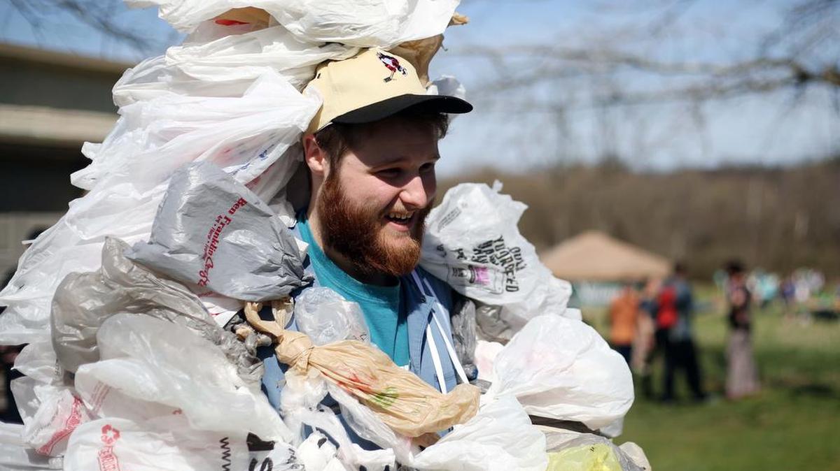 Caleb Myer, “The Bag Monster,” wears a suit made out of 500 plastic bags during the Millbrook Marsh Earth Day celebration Sunday, April 9, 2017 at Millbrook Marsh Nature Center.
