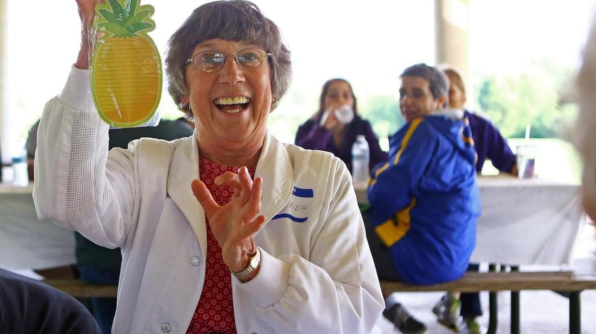 Linda Lochbaum, president of the Cancer Survivors’ Association, shows off her pineapple-shaped notepad won in a game of bingo at Tom Tudek Memorial Park on Sunday, June 5, 2016.