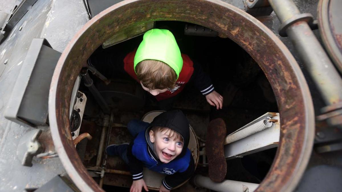 Cooper Yarger, 5, top, and Colton Yarger, 3, sit in the M59 armored personnel carrier during the Exploring the Armor tour Sunday at the Pennsylvania Military Museum.