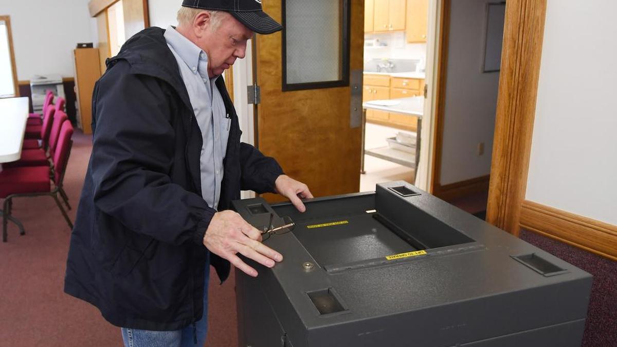Halfmoon Christian Fellowship Church trustee Richard Harpster sets up voting equipment at the church Monday in preparation for Election Day on Tuesday. Polls will be open from 7 a.m. to 8 p.m.