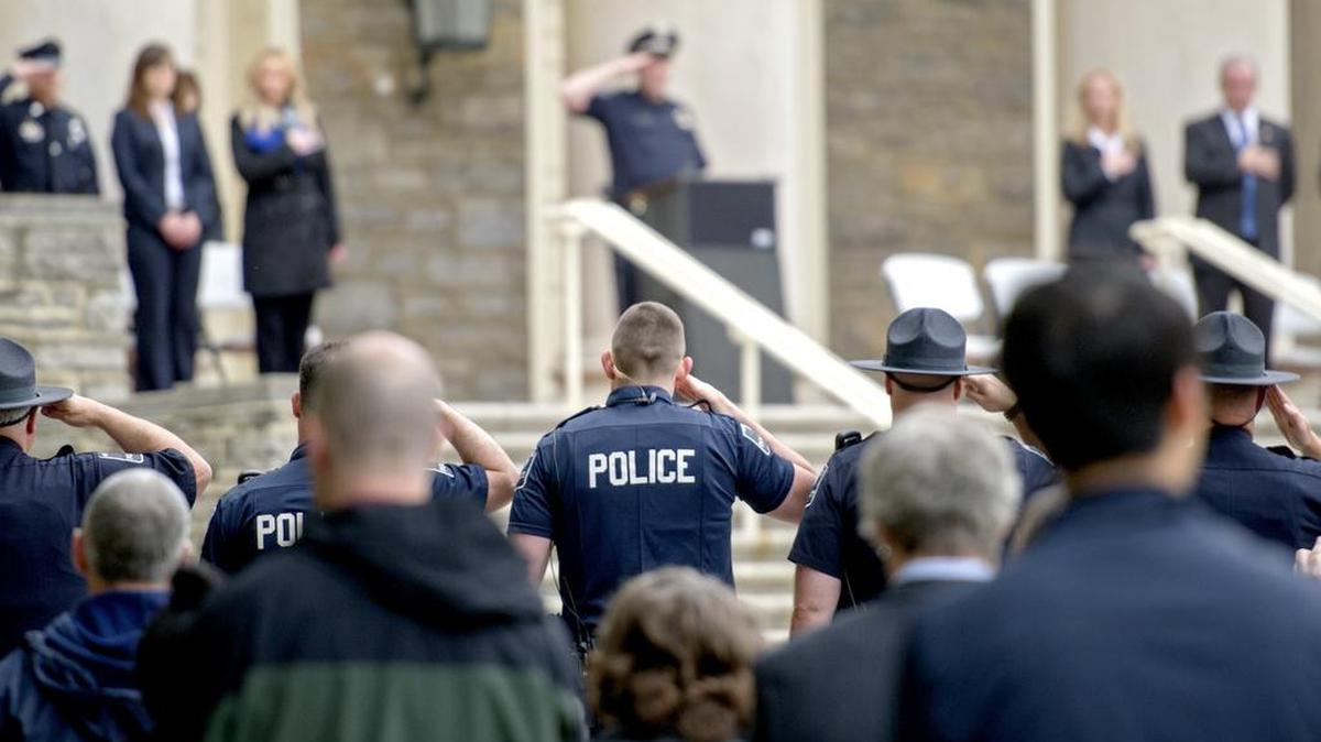 Police stand at attention as the colors are advanced to begin the Centre County Law Enforcement Memorial Ceremony on Wednesday, May 18, 2016, on the steps of Old Main.