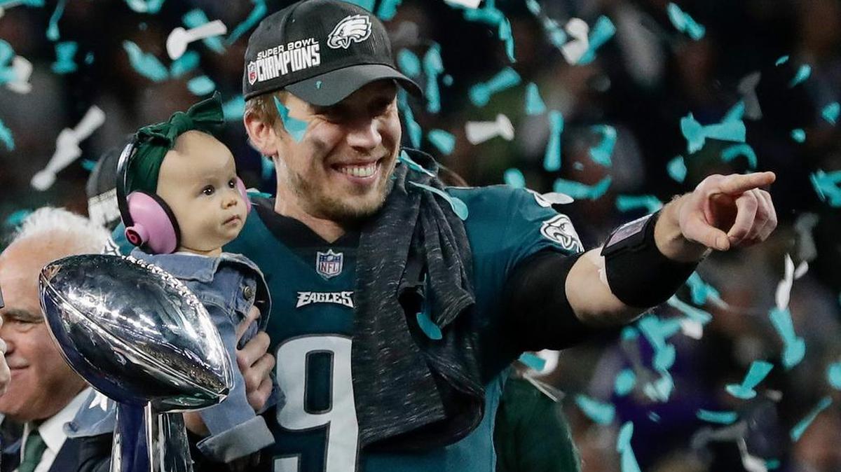 Philadelphia Eagles’ Nick Foles holds his daughter, Lily, after beating the New England Patriots in the NFL Super Bowl 52 football game Sunday in Minneapolis.