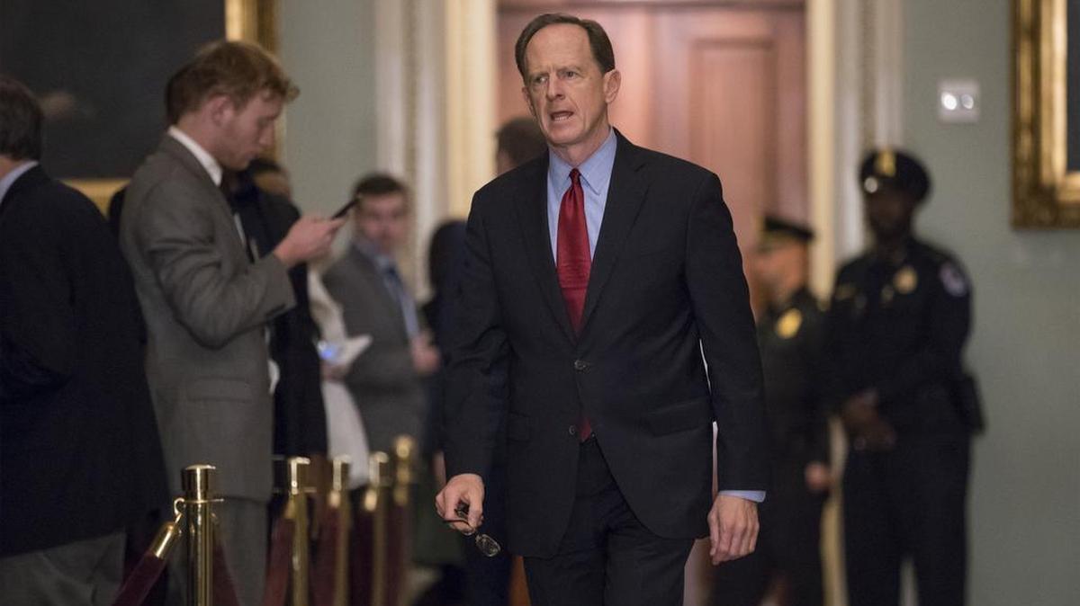 Sen. Pat Toomey, R-Pa., walks to the chamber on Dec. 5, following weekly strategy meetings, on Capitol Hill in Washington.
