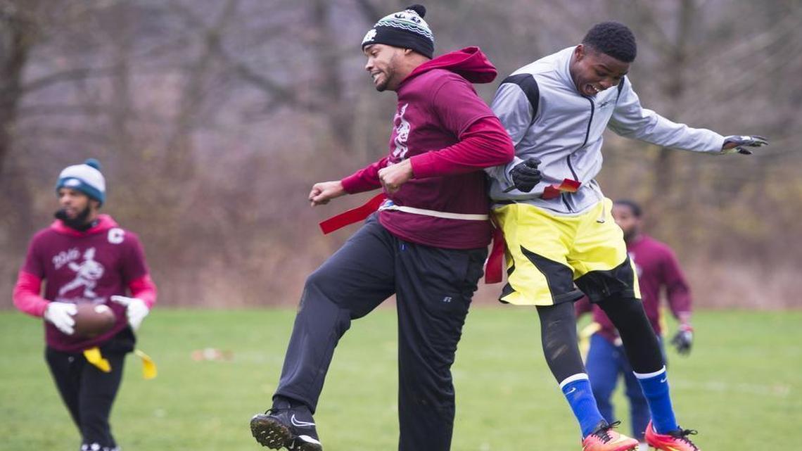 Isaiah Edwards, right, celebrates with Rasheed Welsh after Isaiah’s touchdown during an annual Thanksgiving family football game on Thursday at Spring Creek Park.