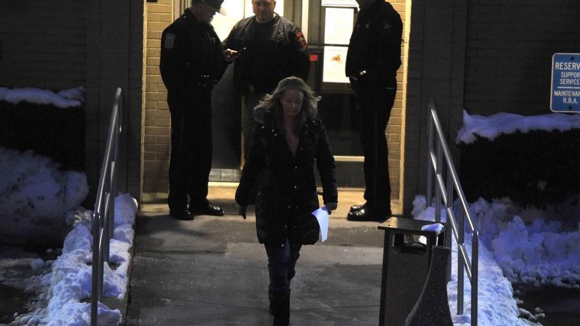 Centre County District Attorney Stacy Parks Miller leaves the courthouse in Bellefonte in 2015, as police conduct a search warrant.