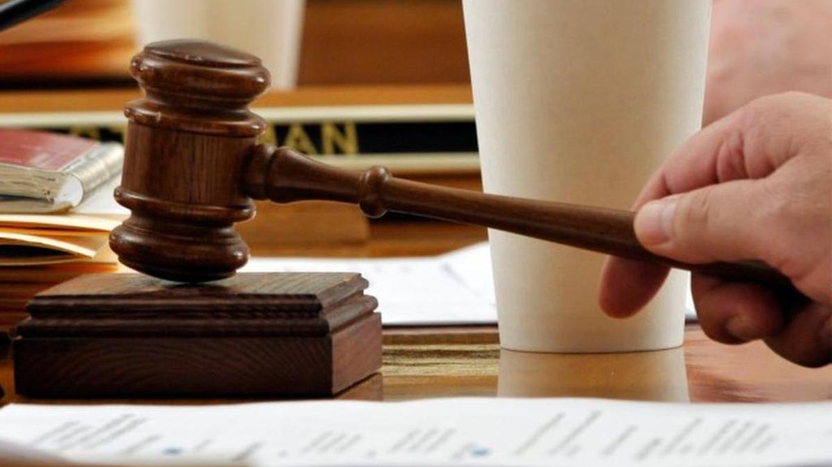 A gavel is shown in a courtroom.