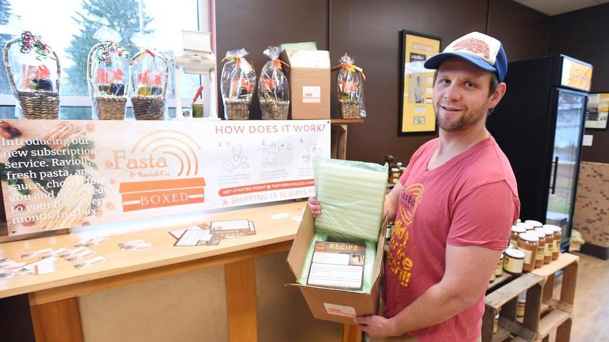 Bob Ricketts, of Fasta Pasta, holds up a box they plan to use for the company’s new subscription service at Fasta Pasta in Pleasant Gap.
