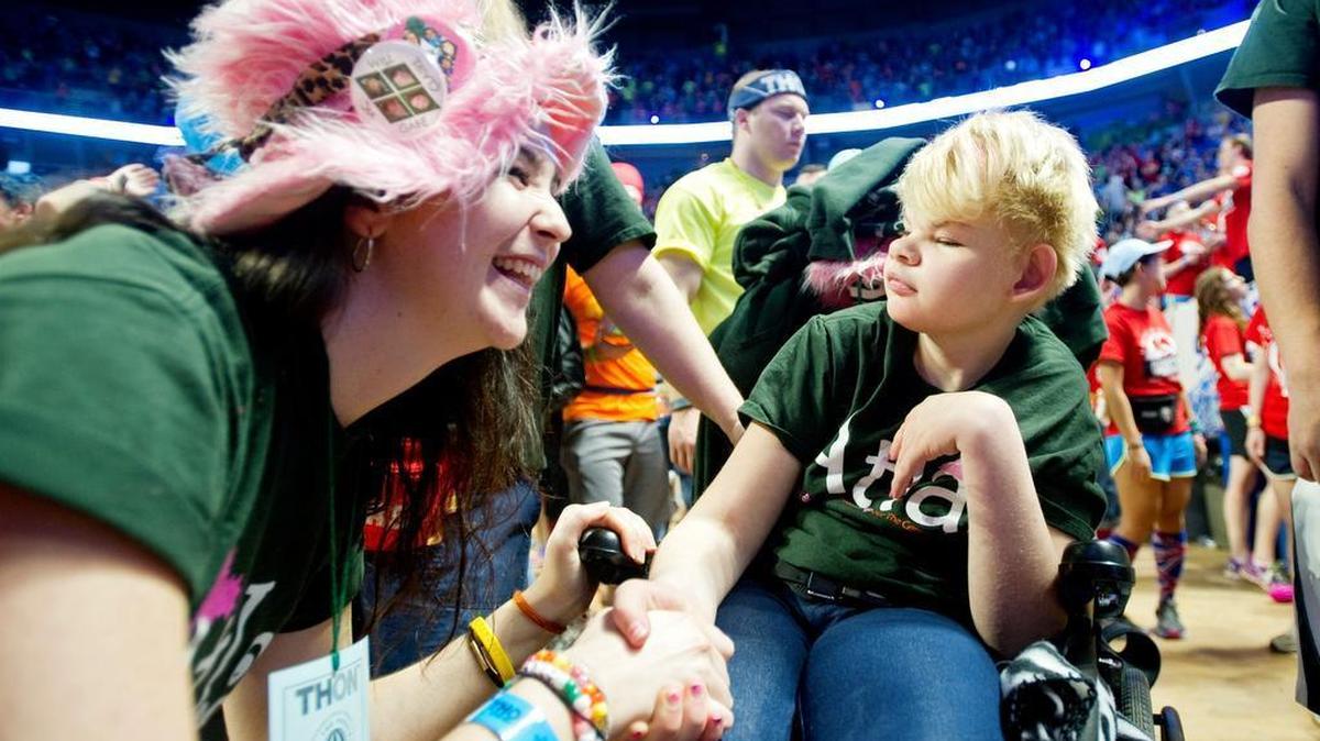 Atlas members laugh with Four Diamonds child Victoria Smith, now 13, during the Penn State IFC/Panhellenic Dance Marathon in 2014 at the Bryce Jordan Center. Victoria, an eighth-grader, is a volunteer with State College Mini-Thon.
