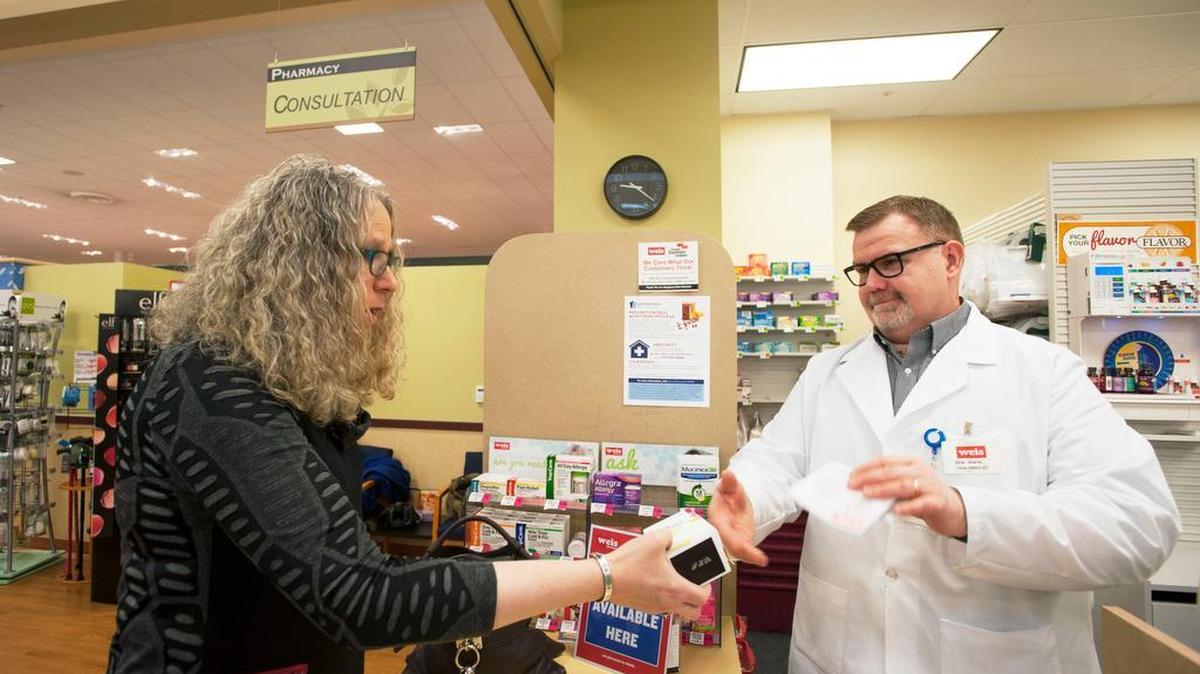 Weis Pharmacy manager Bob Irwin hands Pennsylvania Physician General Dr. Rachel Levine Naloxone on Friday, Jan. 6, 2017, at Weis Markets in Bellefonte. Naloxone is a life-saving opioid overdose reversal drug.