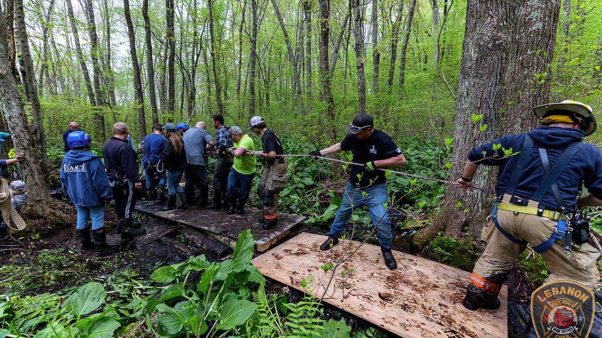 A team of 40 people and fire rescue personnel waded through water and thick mud to rescue two horses that were trapped up to their bellies at a rescue farm in Connecticut.