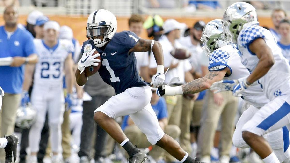 Penn State wide receiver KJ Hamler runs from Kentucky defenders during the Citrus bowl on Tuesday, Jan. 1, 2019 at Camping World Stadium.