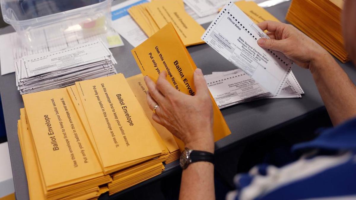 Scott Soukup takes ballots out of envelopes as one of the steps in the counting of absentee ballots on Thursday, Nov. 3, 2016. Hundreds of volunteers and election officials started the absentee ballot count for all of the Hennepin County cities in Minnesota, except Minneapolis. (Tom Wallace/Minneapolis Star Tribune/TNS)