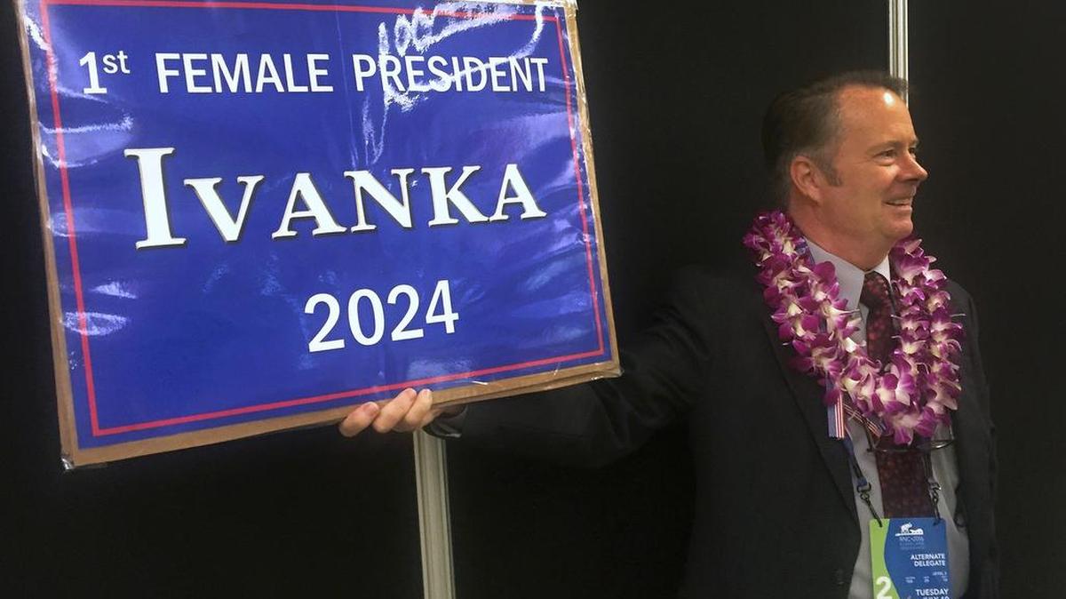 Retired Army colonel and consultant Allen Frenzel, an at-large delegate from Hawaii, displays his sign in support of Ivanka Trump as he waits to enter the Quicken Loans Arena in Cleveland for the Republican National Convention on Tuesday.