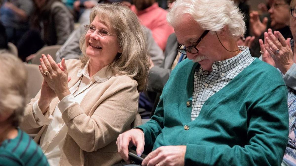 Steff Waltz, left, and her husband Joseph Waltz, right, of Lock Haven, clap as Kerith Strano Taylor, Democratic candidate for the U.S. House of Representatives in Pennsylvania’s 5th District, gives her closing statement at the League of Womens Voters of Centre County’s General Election Candidate’s Night in State College on Thursday.