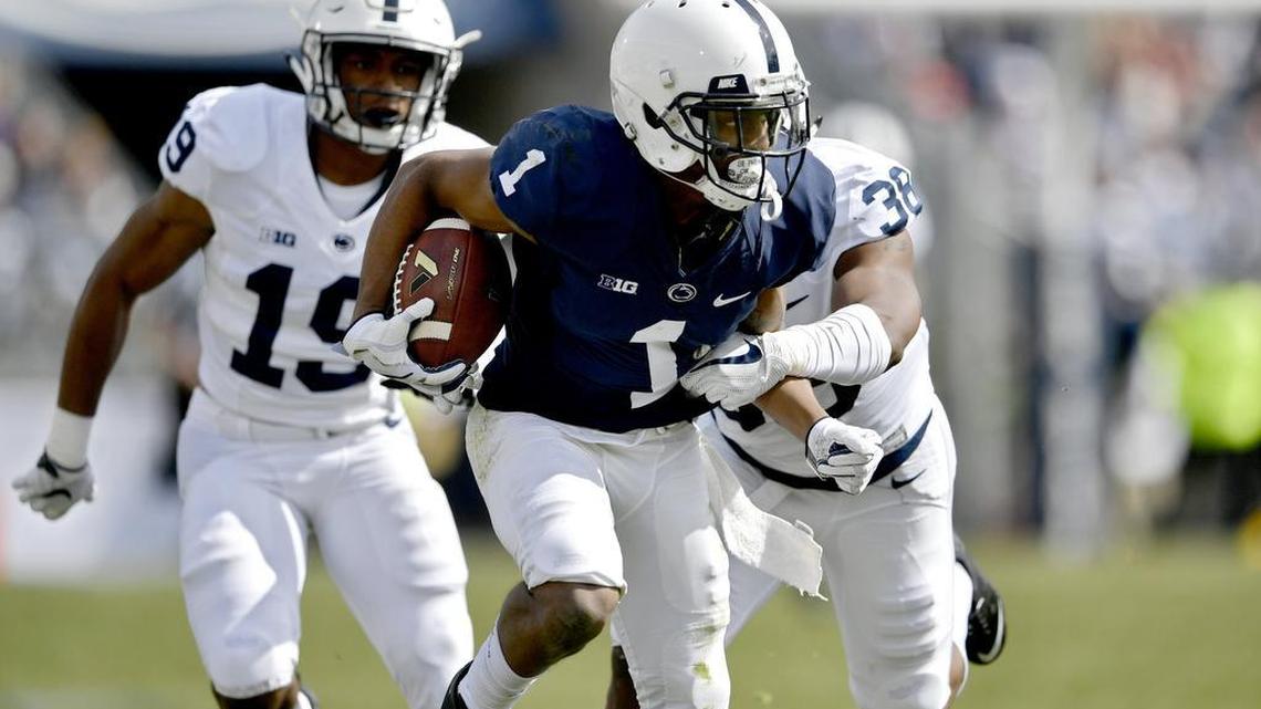 Penn State wide receiver KJ Hamler runs down the field with the ball before safety Lamont Wade knocked the ball away from him and the white team recovered the ball during the Penn State Blue-White Game on Saturday, April 21, 2018.