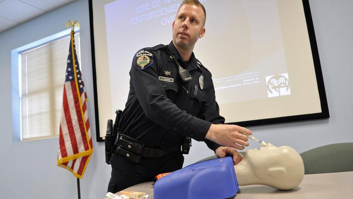 State College police Officer Adam Salyards demonstrates how to use the nalozone hydrochloride on a dummy. The state GOP House spending bill would eliminate $10 million of funding for Naloxone, a drug used to reverse opioid overdoses.