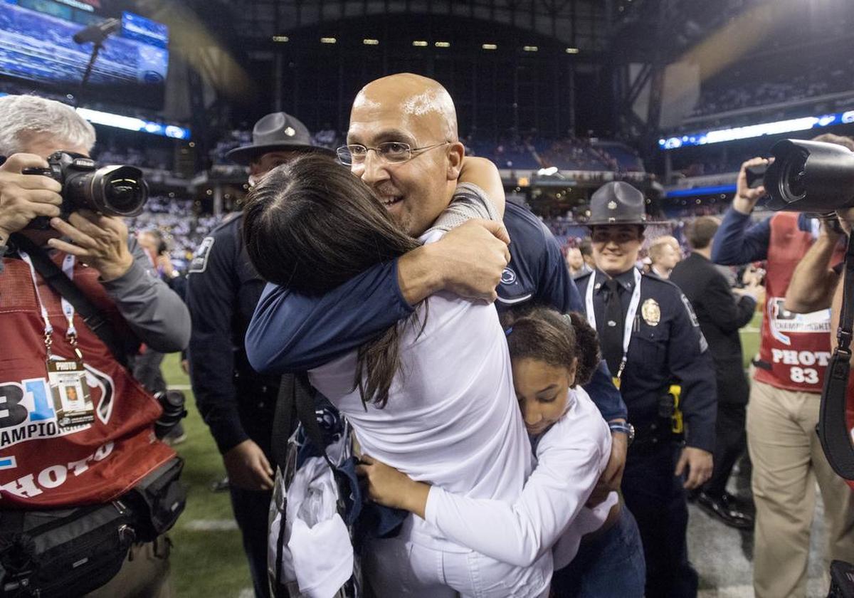 Penn State football coach James Franklin hugs his wife Fumi and daughter Shola after winning the Big Ten Championship game on Saturday, December 3, 2016 at Lucas Oil Stadium. 